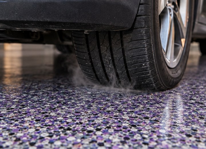 Warm rubber contact — visual example for What is hot-tire pickup and how can a floor system prevent it?